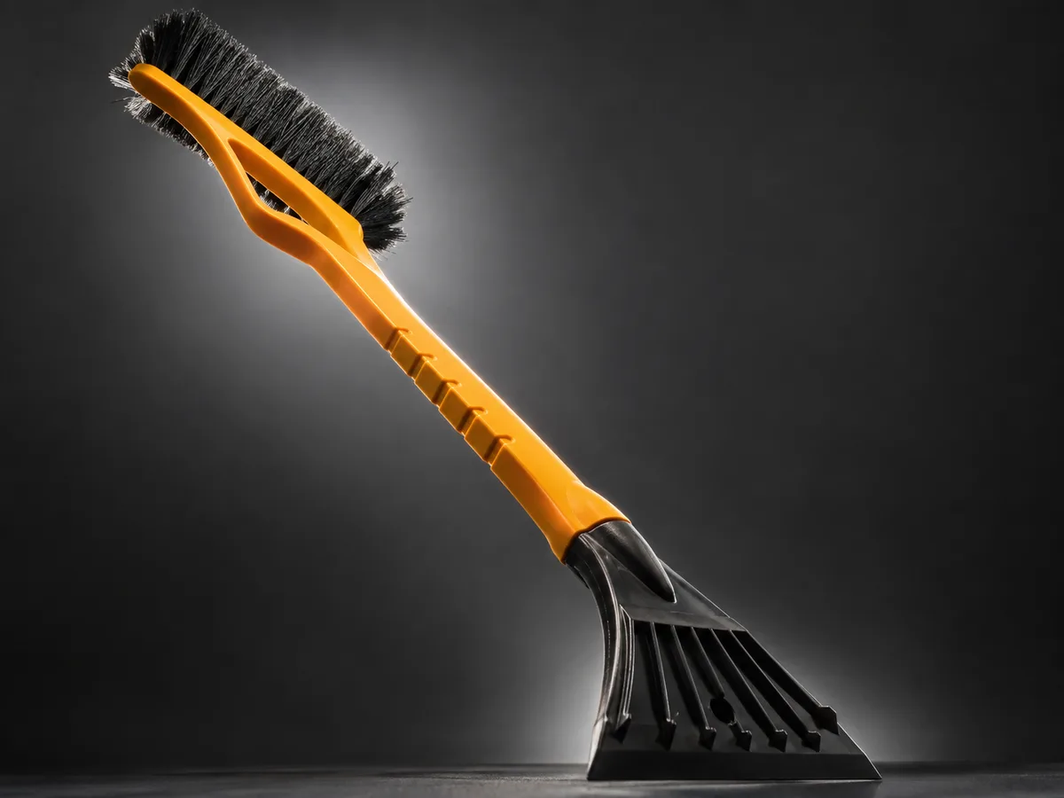 Car snow brush at a heroic angle