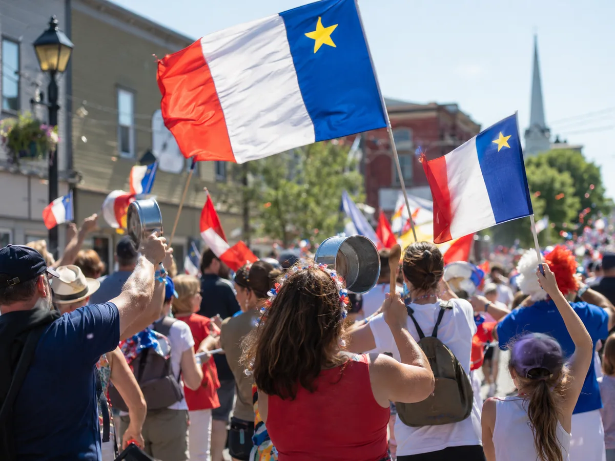 Tintamarre parade, Acadian flags and noisemakers